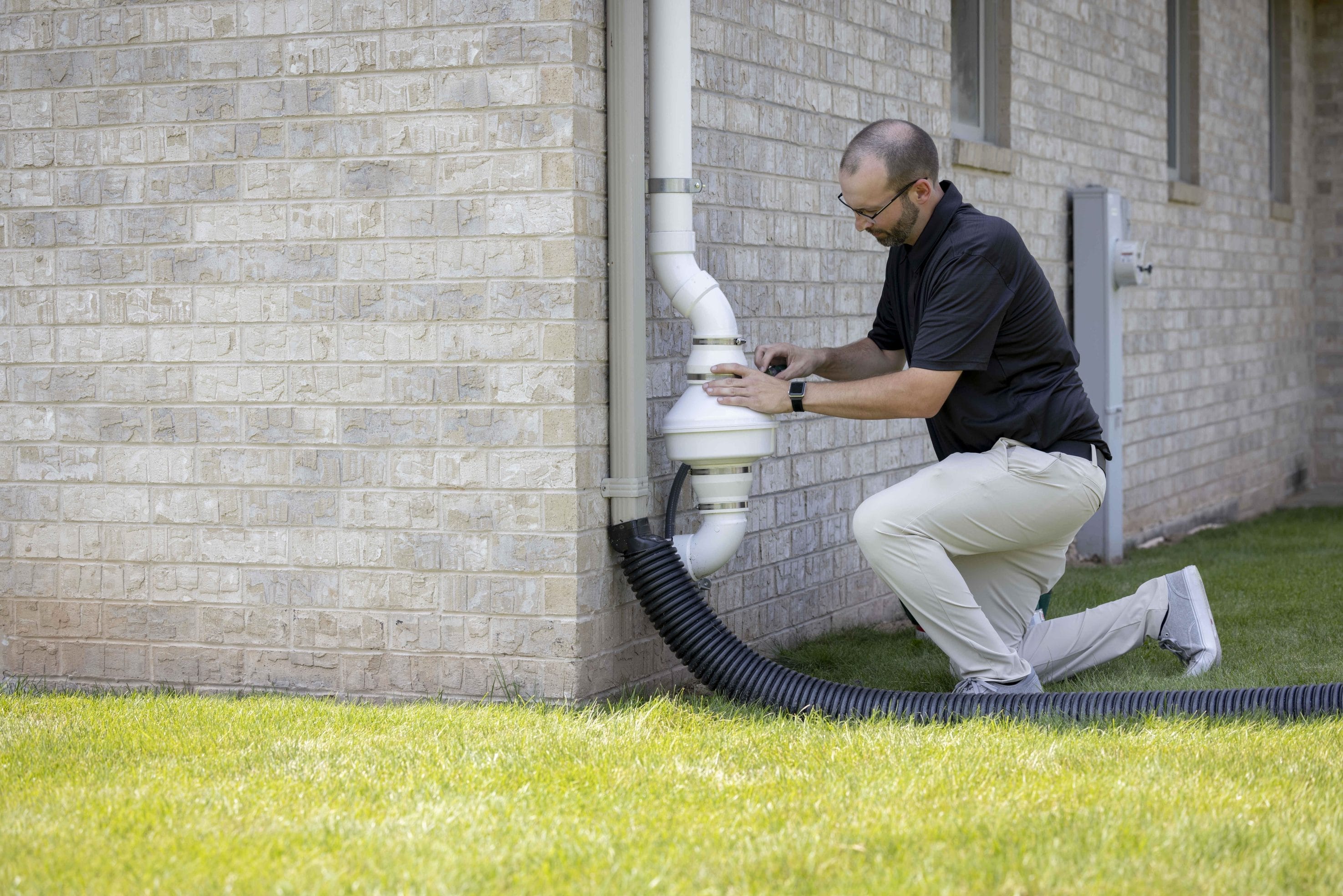 Exterior Commercial Radon System Inspection in Progress