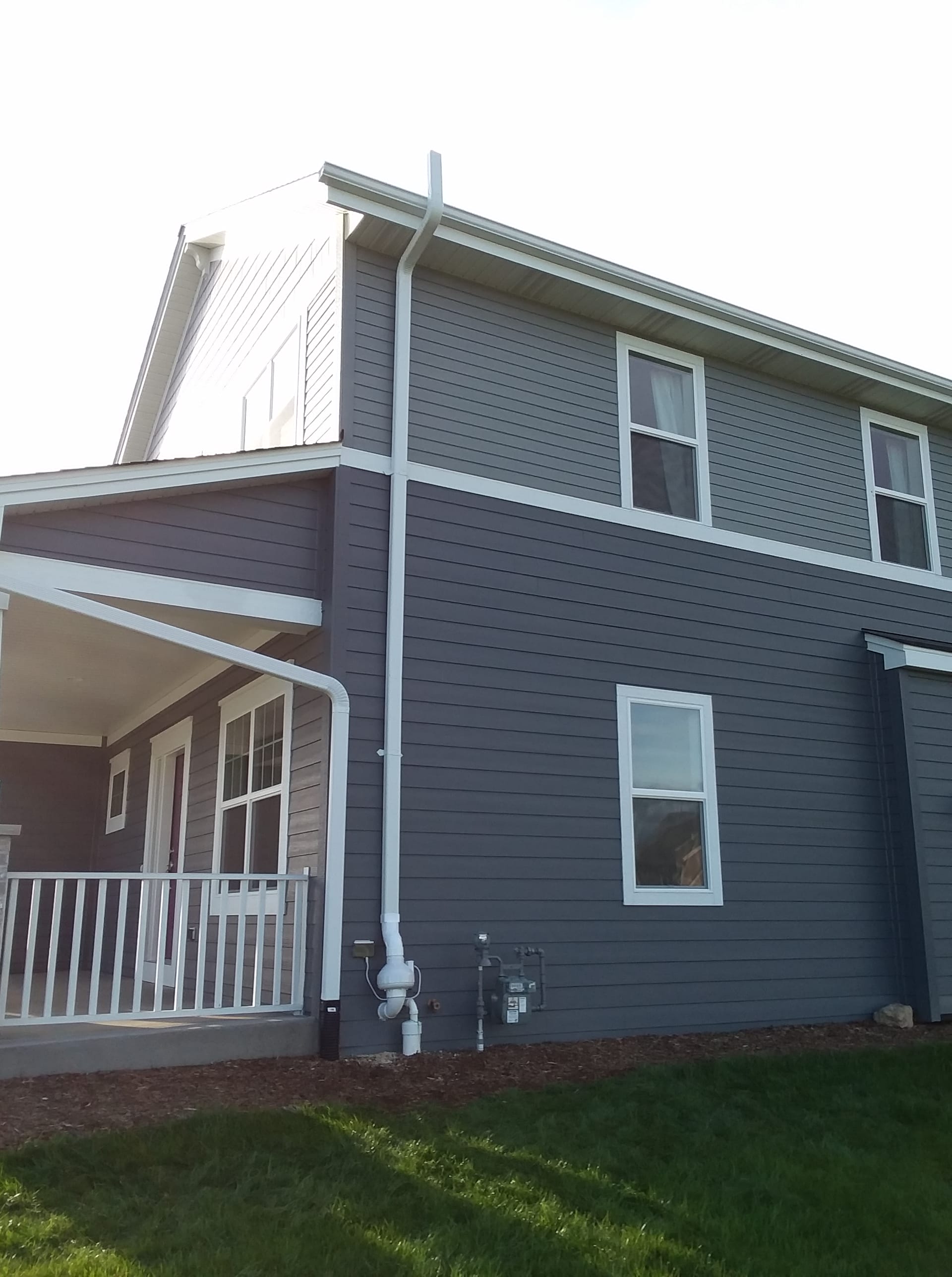 Radon mitigation system installed on residential home exterior
