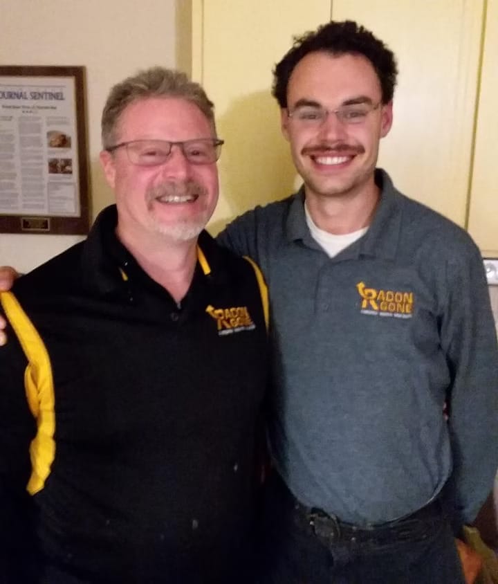 Radon Gone Technicians Smiling After Successful Mitigation Installation
